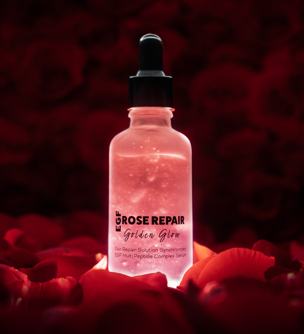 zoomed in bottle of rose repair serum on a bed of rose petals