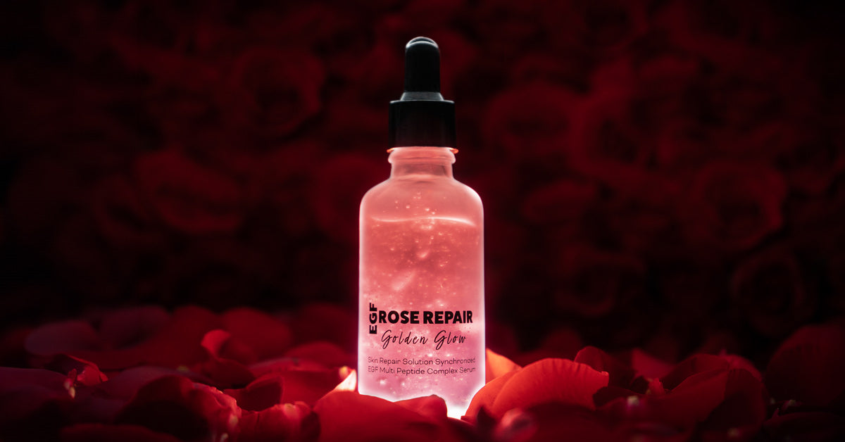 bottle of rose repair serum on a bed of rose petals 