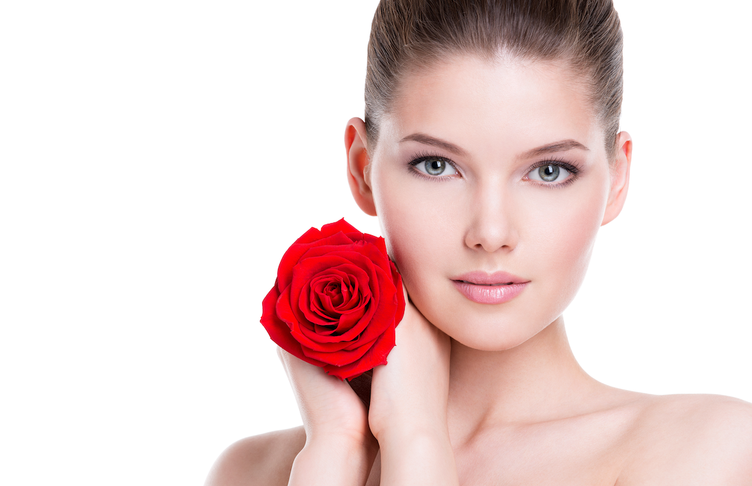 model hold a red rose with both hands next to her face