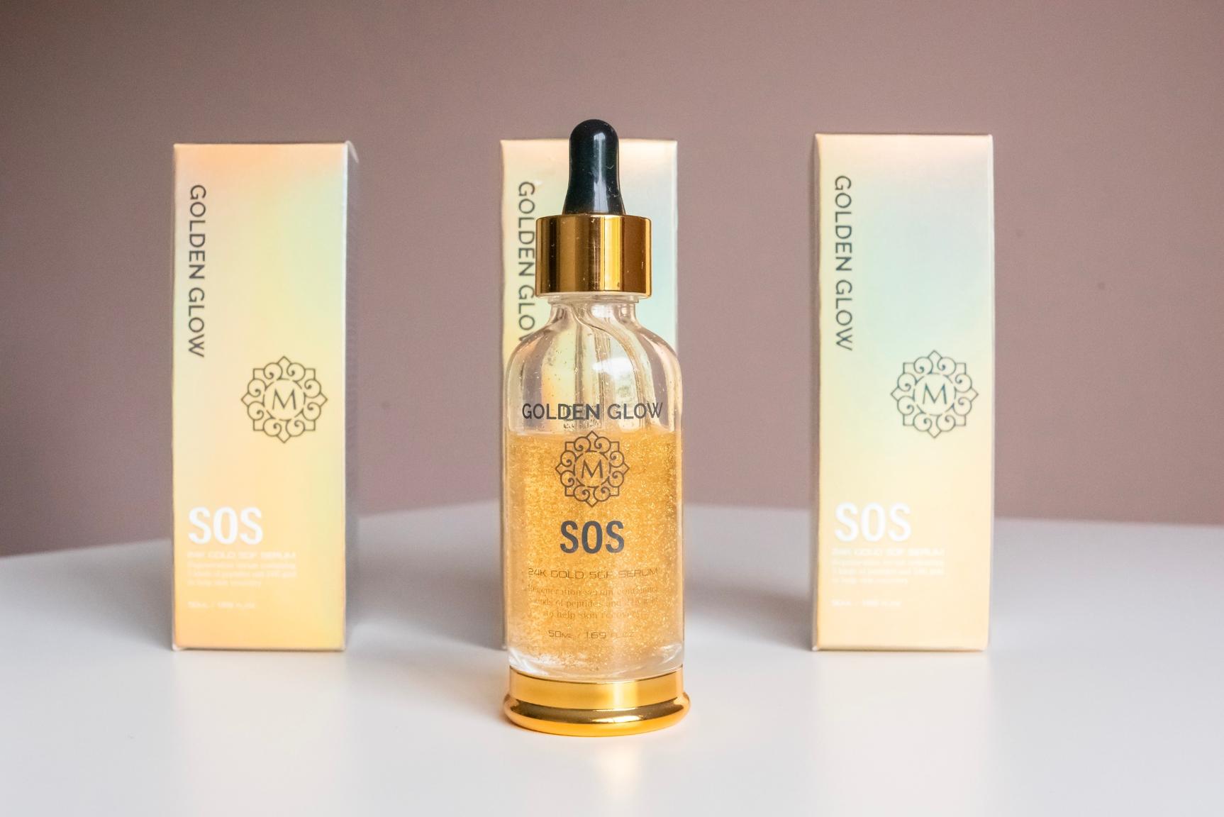 a bottle of golden glow sos on a white surface with two packages of on each side